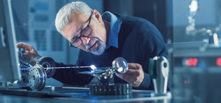 Image of optical engineer working on lens
